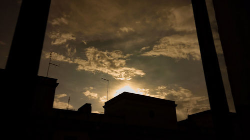 Low angle view of building against cloudy sky