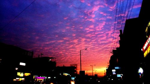 Low angle view of illuminated buildings against sky at dusk