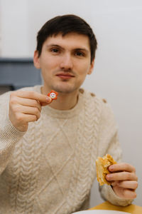 A young man shows a surprise from a piece of royal galette.