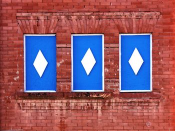 Blue sign on brick wall