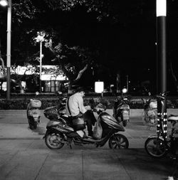 People riding bicycles on street at night