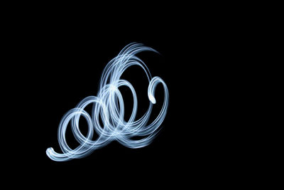 Close-up of light painting against black background