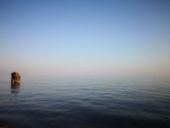 Scenic view of sea against clear sky during sunset