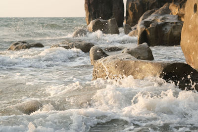 Water splashing on rocks at beach