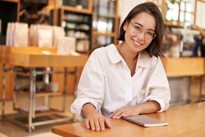 Portrait of businesswoman working at table