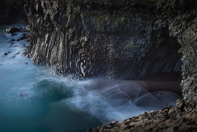 Scenic view of sea against rock formation