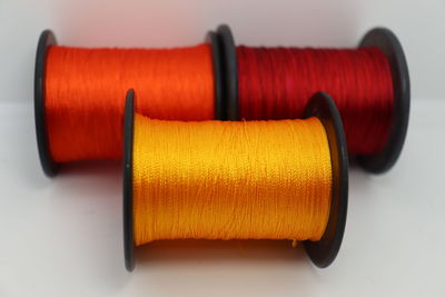 Close-up of orange ring on table against white background