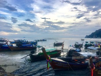 Boats moored on sea against sky