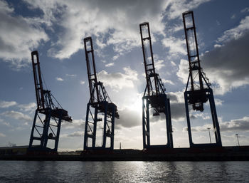View of harbor against cloudy sky