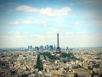 Cityscape against cloudy sky