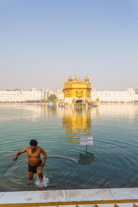 Rear view of man standing in temple