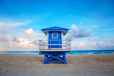  tropical florida landscape with blue lifeguard house at sunset twilight. american beach ocean nature 