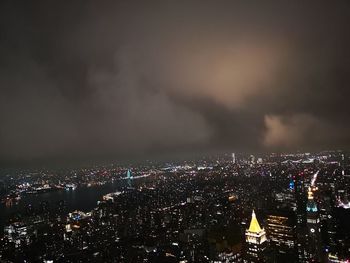 High angle view of illuminated buildings against sky at night