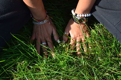 Midsection of woman on field during sunny day