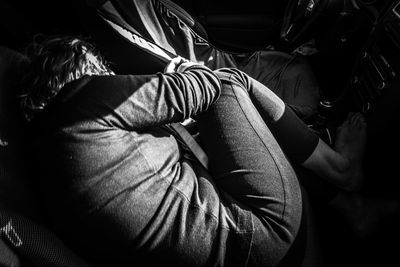 High angle view of woman sleeping in car