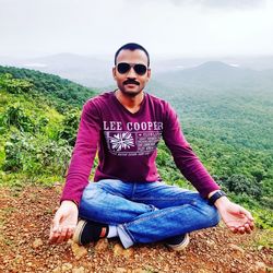 Portrait of man sitting on land