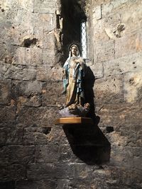 Statue of buddha against wall