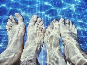 Low section of woman standing on tiled floor