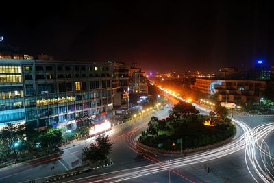 High angle view of light trails on road in city at night