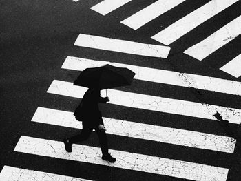 Shadow of man walking on street