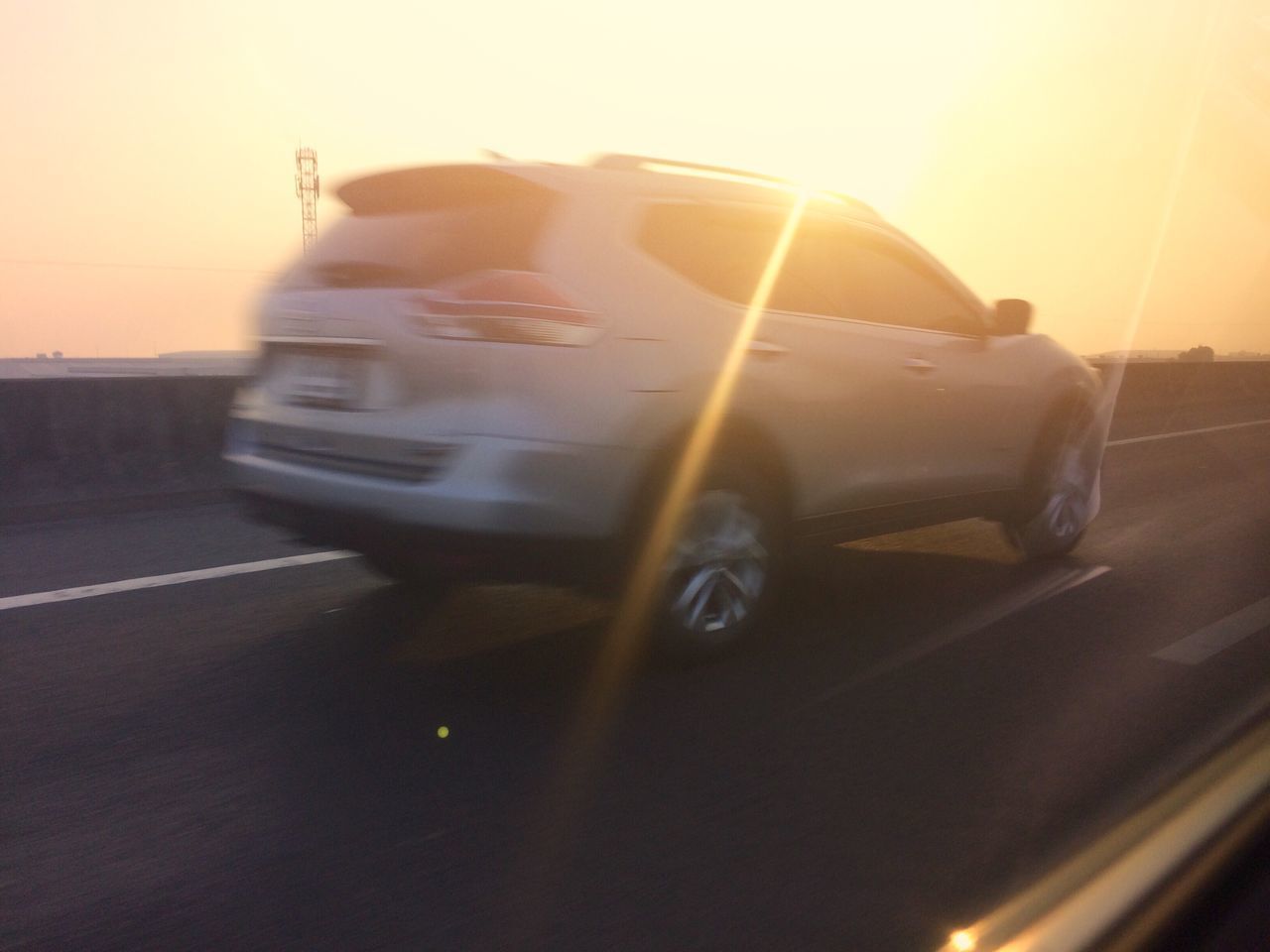 CAR ON ROAD AGAINST SKY