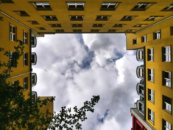 Low angle view of building against cloudy sky