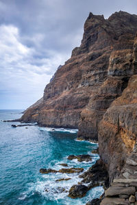 Scenic view of sea and rock formation against sky