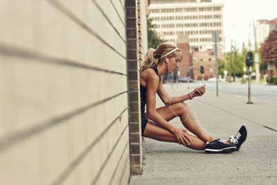 Young woman using mp3 player