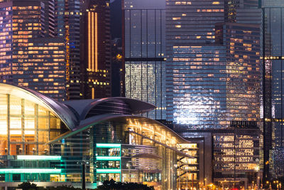 Illuminated cityscape against sky at night