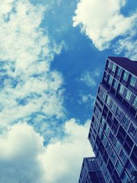 Low angle view of modern office building against sky