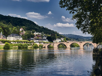 Arch bridge over river against sky