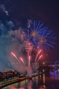 Low angle view of firework display at night