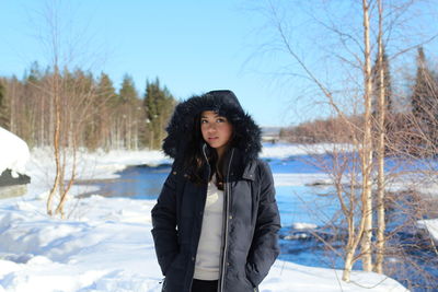 Young woman standing on snow covered land