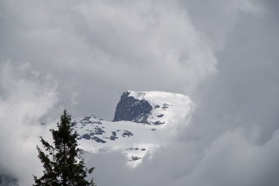 Low angle view of snowcapped mountain against sky