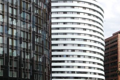 Low angle view of modern building in city against sky