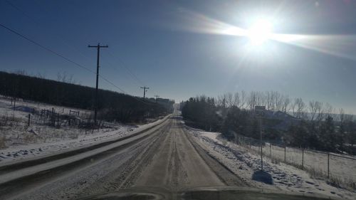 Sun shining over road