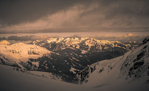 Scenic view of snowcapped mountains against sky during sunset