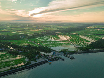 High angle view of river amidst city against sky