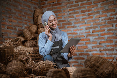 Portrait of young woman using phone