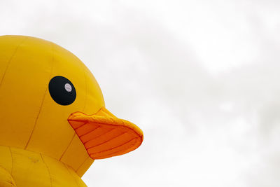 Part of giant rubber duck against sky