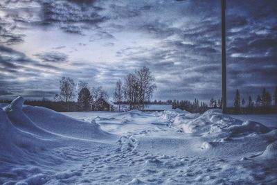 Snow covered landscape against sky