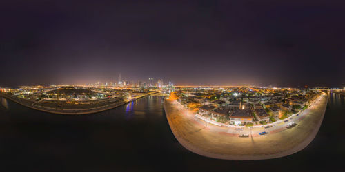 High angle view of illuminated buildings against sky at night