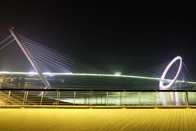 Illuminated nanjing eye over river against clear sky at night