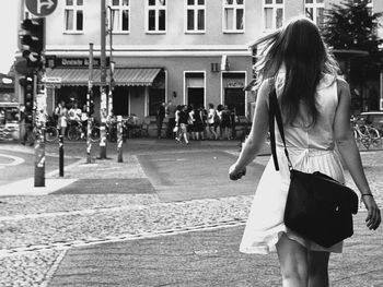 Woman with umbrella walking in city