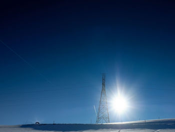 Low angle view of cables against blue sky