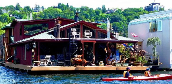 Boats in river with buildings in background