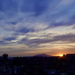 Cityscape against sky during sunset