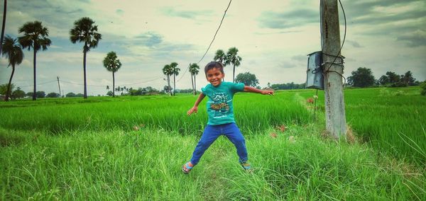 Full length portrait of boy on field