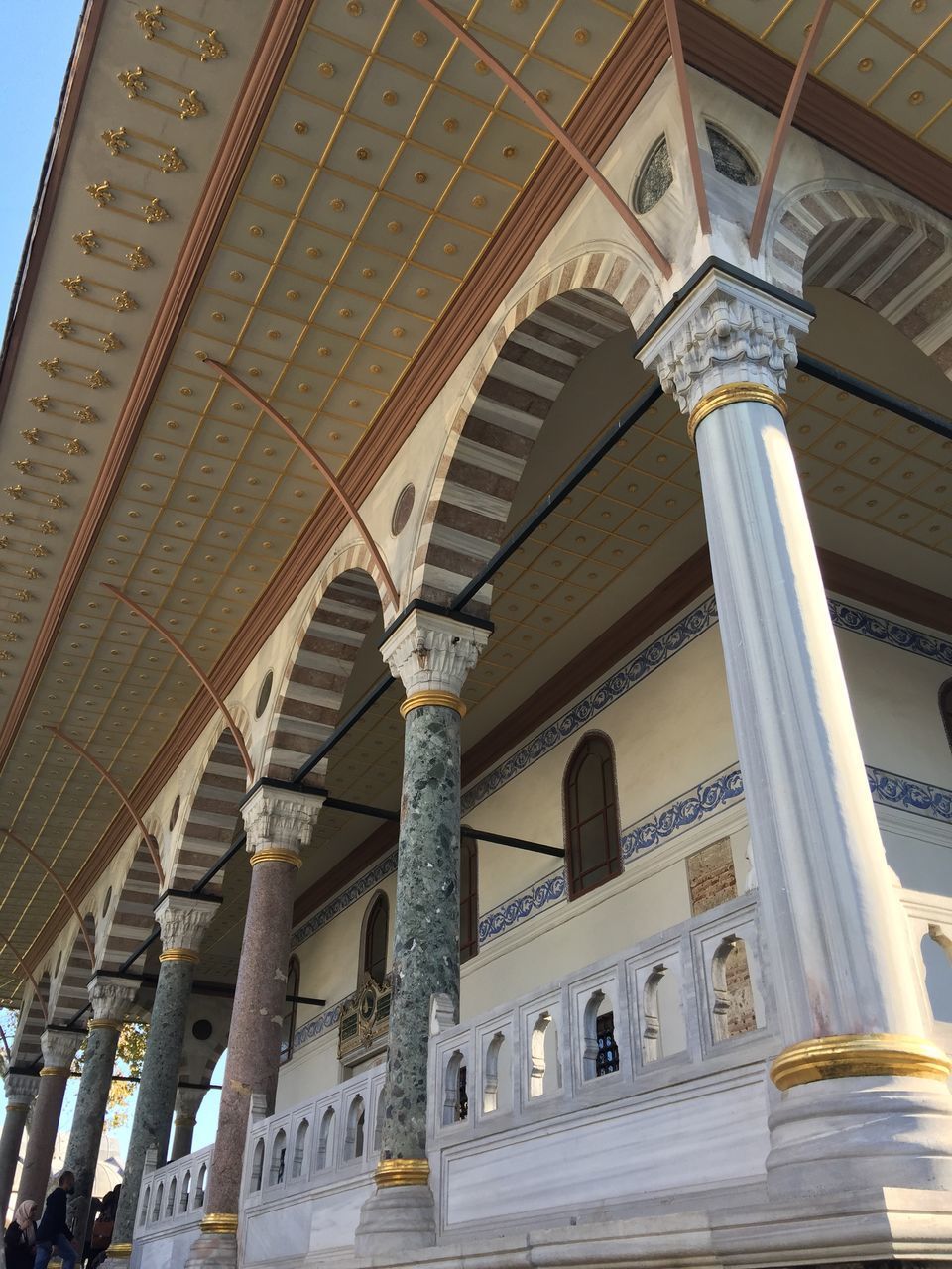 LOW ANGLE VIEW OF COLONNADE AND BUILDINGS IN CITY