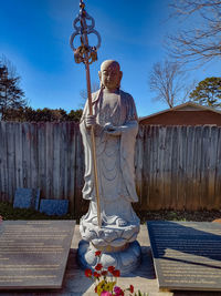 Statue against trees and sky